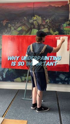 a person painting on a wall with a red sign that says why unpainting is so important