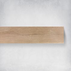 a wooden sign hanging from the side of a wall on a white wall background with copy space