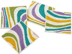 three placemats with multicolored stripes on them