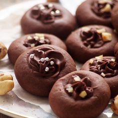 there are chocolate cookies with nuts on the plate