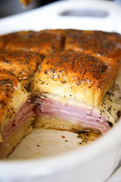 ham and cheese sliders on a plate with text overlay that reads ham and cheese sliders