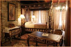 a bed room with a neatly made bed and two lamps on either side of the bed