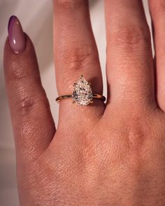 a woman's hand with a diamond ring on it