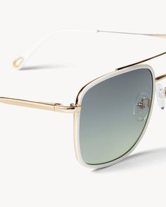 Ultra lightweight aviator sunglasses with frames crafted from gold metal details and Italian acetate. Includes UV 400 protective lenses. White Aviator Sunglasses With Uv Protection, Elegant White Aviator Sunglasses With Tinted Lenses, Classic White Aviator Sunglasses With Gradient Lenses, White Aviator Sunglasses With Tinted Lenses, Trendy White Sunglasses With Metal Frame, Modern White Sunglasses With Metal Frame, Summer White Anti-reflective Aviator Sunglasses, Gold Aviator Sunglasses With Anti-reflective Coating, Cheap Gold Aviator Sunglasses With Anti-reflective Details