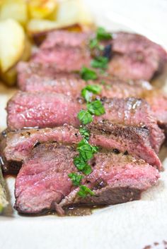 some meat and potatoes on a white plate