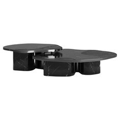 two tables with black marble tops on each side and one table is shaped like an oval