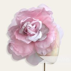 WOWZA! Meet 'Pricilla', by far our largest and most flamboyant millinery flower. Ideal for Royal Ascot, this over-the-top candy pink flower is made up of giant floaty organza and silk petals with velvet accent petals at it's centre. It's an absolute whopper of a flower!  Try putting two on a fascinator base or headband for an instant statement hat!  Flower measures: Width: Around 25cm (10 inches) when splayed out Length of wired stem: 9cm (3.5 inches) For our full range of velvet hat flowers vis Making Candy, Sinamay Fabric, Statement Hat, Hat Flower, Candy Flowers, Hat Base, Velvet Hat, Velvet Accents, Velvet Flowers