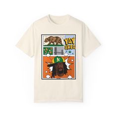 This graphic tee is a tribute to both the legend that is Mac Dre and the Yay Area (Bay Area) of Northern California . A digitally drawn portrait of the artist is paired with comic style details and other images that represent the Northern part of California.  Direct to Garment printing of the graphic allows for all the vibrant colors to show clearly over the dye on each tee.  Available in a handful of colors from white to pink to army green to grey to black.  Printed on The Comfort Colors 1717 garment-dyed t-shirt  100% ring-spun cotton  Relaxed fit (Go up a size for an oversized fit.) Pre-shrunk  HIGHLY recommended to wash the tee inside out and hang dry to preserve the life of the item. *Please allow 3-5 days for production after order is placed.* NOT INCLUDING SHIP TIME It is possible t Mac Dre T Shirt, Artistic Graphic T-shirt For Streetwear, Mac Dre, Yay Area, Comic Style, The Dye, Comic Styles, Go Up, Northern California