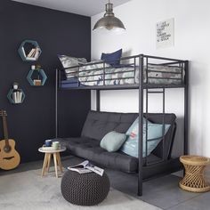 a living room with a futon bunk bed next to a black couch and table