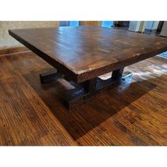 a wooden table sitting on top of a hard wood floor