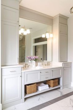 a bathroom with two sinks and large mirrors