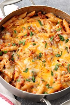 a casserole dish with meat, cheese and sauce in a pan on a table