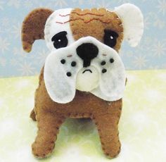 a stuffed dog is sitting on a table with it's face covered by its paw