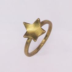 Delicate gold-coloured Star Stacker Rings. Perfect to wear alone and by stacking it with your other favourite rings. These lovely Star Stackings rings are available in brass (gold colour), silver or 18K gold plating. Size: UK A - UK Q Thickness: 1,5 mm Width: 2 mm Star detail: around 10 x 10 mm Please note: The 18K gold-plated jewellery will take 10 business days to prepare. The processing time for the silver and brass jewellery is 1-3 working days. Wide Gold Ring, Silversmithing Jewelry, Triple Band Ring, Minimalist Silver Ring, Gold Minimalist Jewelry, Brass Jewellery, Mens Band Rings, Star Charm Necklace, Stacker Rings