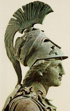 an ancient roman statue wearing a helmet with feathers on it's head and shoulders