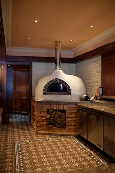 a large brick oven sitting inside of a kitchen