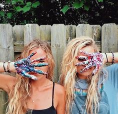 two girls with their hands painted to look like they are holding something