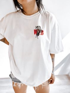 These tees are printed on super soft Comfort Colors, providing a relaxed unisex fit with a worn-in look and feel. This collection offers our most expanded size range from S-3X.Looking for these tees to fit oversized? Size up 1-2 sizes.Model has sized up to an XL for an oversized fit.• 100% ring-spun cotton• Garment-dyed• Relaxed fitThis product is made especially for you as soon as you place an order, please see the banner on the top of our site for current turnaround times. Making products on d Graphic Tee With White Print And Crew Neck, Short Sleeve T-shirt With White Back Print, Relaxed Fit White Graphic Tee, White Graphic Tee In Relaxed Fit, White Print Cotton T-shirt With Back Print, Cotton Graphic Tee With Back Print, Graphic Cotton Tee With Back Print, Graphic Tee Cotton Shirt With Back Print, White Trendy T-shirt With Back Print