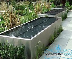 a water feature in the middle of a garden