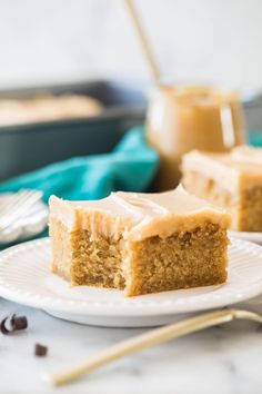 two pieces of cake sitting on top of a white plate next to a cup of coffee