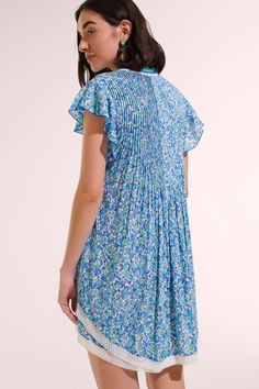 The Sasha dress from Poupette St. Barth is one of their best selling silhouettes. It has a trapeze shape with a striking fringed v-neck, butterfly sleeves, and a curved double hem trimmed in lace. Offered in Blue Ocean Flowers. 100% eco-responsible Viscose Hand wash cold. Hang dry. Made in Indonesia Embroidered V-neck Beachwear Dress, Beach Season V-neck Mini Dress With Ruffles, Ocean Flowers, Blue V-neck Mini Dress With Boho Print, Beach Mini Dress With Lace Trim And V-neck, Beach Mini Dress With Floral Embroidery And V-neck, Hemant And Nandita, Sleepwear Dress, Tanya Taylor