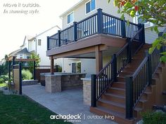 an outdoor patio with stairs and grill area