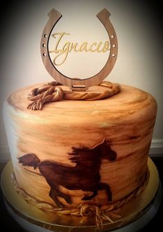 a cake with a horse on it and the name ingnacco written in gold