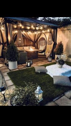 an outdoor living area is lit up with string lights