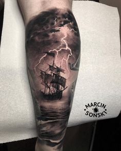 a man's arm with a ship on it and lightning coming from the sky