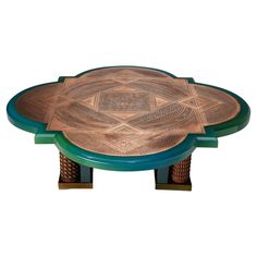 an intricately designed wooden table with green legs