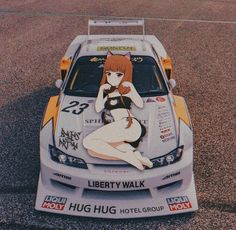 a woman sitting on the hood of a car