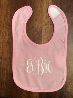 This is a 100% cotton jersey knit bib with a Velcro closureCan be monogrammed in a vine font as well as a masculine font for boysIf there is something other than a monogram you would like such as a name, just let me know and we should be able to make it.Chose the bib color then the color of the design.Let me know in the personalization area what you would like on the bib and any special instructions such as font type or color requests. Customizable White Cotton Bib, Personalized Cotton Bib As Gift, Masculine Font, Boy Fonts, Vine Font, She Mask, Custom Wedding Rings, Unisex Baby Clothes, Photo Mask