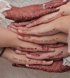 the brides hands are covered with hennap and words that spell out their names