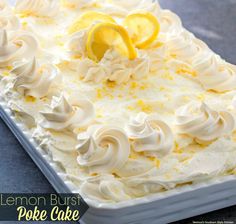 a close up of a cake with lemons on top and icing around the edges