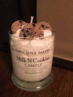 a glass jar filled with cookies on top of a wooden table