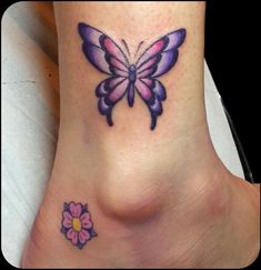 a small butterfly tattoo on the side of a woman's foot with a flower