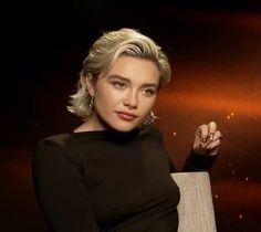 a woman with blonde hair sitting in a chair