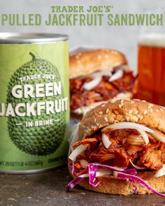 a close up of a sandwich on a table near a can of green jackfruit