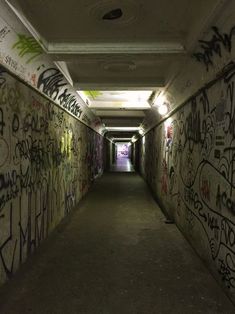 a long tunnel with graffiti all over it