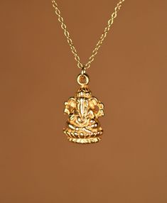 Ganesha necklace - gold ganesha - indian god - ganesh - yoga necklace - a 14k gold vermeil ganesha on a 14k gold filled chain A 14k gold plated sterling silver ganesha indian god hangs from a 16 inch 14k gold filledl chain. Please feel free to select a different length chain if you prefer. This beauty is also available in sterling silver and shiny rose gold vermeil if you prefer! Charm Measurements: 12mmx9mm Ganesha's big belly represents generosity and total acceptance. His upraised hand, depic Spiritual Gold Charm Necklace For Good Luck, Spiritual Gold Plated Necklaces For Festive Occasions, Handmade Gold Temple Necklace Spiritual Style, Spiritual Gold Temple Necklace In Brass, Gold Brass Temple Necklace With Spiritual Style, Spiritual Gold Temple Necklace For Meditation, Spiritual Gold Brass Temple Necklace, Gold Temple Necklace For Festive Occasions, Gold Plated Spiritual Jewelry For Puja