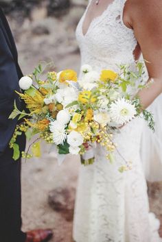 a bride and groom standing next to each other