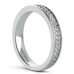 a white gold wedding ring with an intricate design