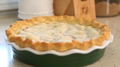 a pie crust in a green dish on a counter