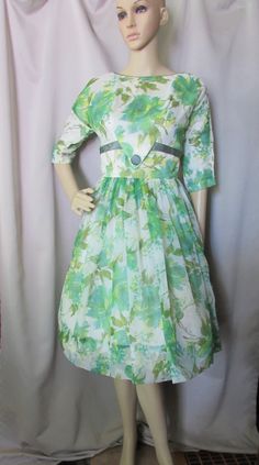 "Fancy 1950 1960 Era full skirted special event dress. In chiffon, the pattern is a stylized spring green, lemon yellow and avocado floral with splashes of teal and sage. The chiffon is over satin and white tulle underskirt. The boat neckline leads to a V-shape panel at the front bodice with a satin sage tone covered button accenting the V. The same 7/8\" ribbon is used to accent an empire waist look that travels to the back for a trailing bow. The 12 1/2\" sleeves are raglan elbow length. The f Spring A-line Vintage Dress For Vintage Events, Retro Vintage Dress With Full Skirt For Events, Retro Full Skirt Vintage Dress For Events, Spring Vintage A-line Dress For Vintage Events, Spring Vintage Full Skirt Dress, Retro Vintage Dress For Spring Events, Spring Tea Length Vintage Dress For Vintage Events, Vintage Full Skirt Dresses For Spring, Spring Mid-century Dresses For Vintage Events