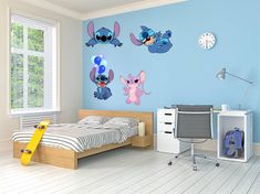 a child's bedroom with blue walls and cartoon wall decals on the wall