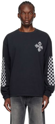 Rhude: Black Cross Long Sleeve T-Shirt | SSENSE Black T-shirt With Crew Neck And Ribbed Cuffs, Urban Black T-shirt With Ribbed Cuffs, Black Crew Neck T-shirt With Graphic Print, Black Graphic Print Crew T-shirt, Black Crew Neck Top With Back Print, Black Long Sleeve Top With Back Print, Black Crew Neck Graphic Tee, Black Graphic Tee With Crew Neck, Black Urban Crew Top