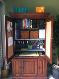 an open cabinet with books and papers on it