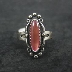 This beautiful Southwestern ring is sterling silver. It features a resin orange moonglow stone. The face of this ring measures 13/16 of an inch north to south. Marks: WM, Sterling WM is the hallmark for the William Wheeler Company Condition: Old new stock - some with tags Southwestern Sterling Silver Opal Ring, Collectible Orange Sterling Silver Jewelry, Southwestern Sterling Silver Cabochon Rings, Southwestern Sterling Silver Ring With Cabochon, Southwestern Sterling Silver Rings With Cabochon, Glow Ring, Orange Moon, Gothic Victorian, Moon Glow