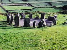 stonehenge standing in the middle of a green field