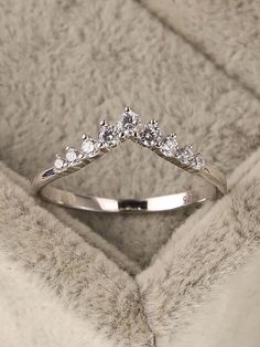 a diamond ring sitting on top of a blanket